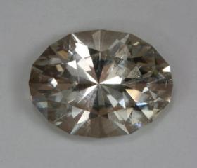 Very pale wheat colored oval that is slightly included.