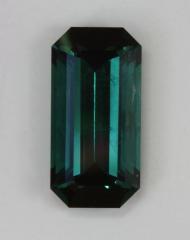 Long ratio, blue to green emerald cut with dark ends.