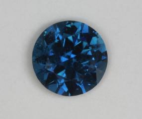 A moving sapphire blue droplet.