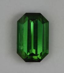 Nice tourmaline green, touch of yellow closed ended emerald cut.