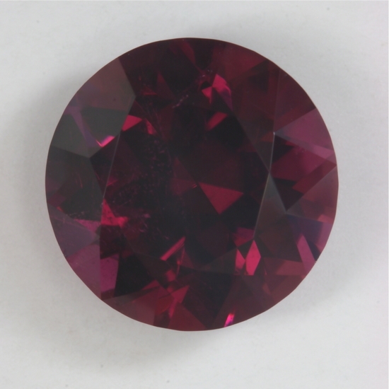 Just big enough to be a red, slightly included round.  #38