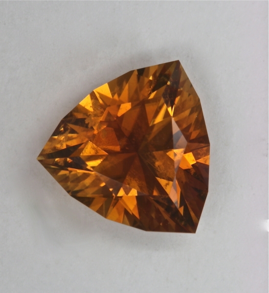 Golden orange trilliant has significant non flashing inclusions.  #179