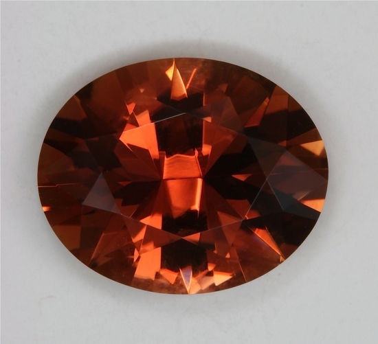 A medium tone dravite of brownish orange/golden color, oval  #258