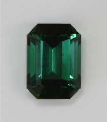 Well saturated blue to green color, slightly flawed, emerald cut.  #382