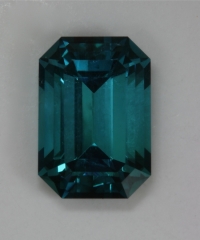 Excellent, open ended, slight dichroism, blue emerald cut.  #385