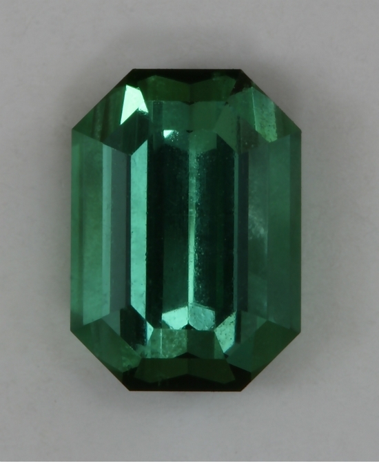 Bright well saturated green emerald cut is slightly included.  #406