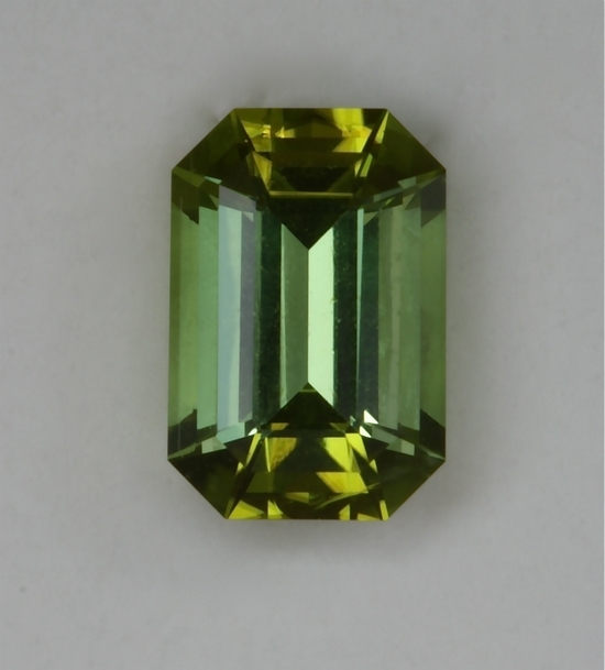 Bright, open end, slightly dichroic, acid green emerald cut.  #407