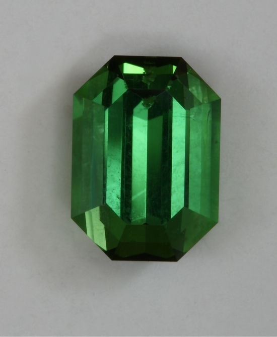 Fine, classical, closed ended, medium toned, yellowish green emerald cut.  #416