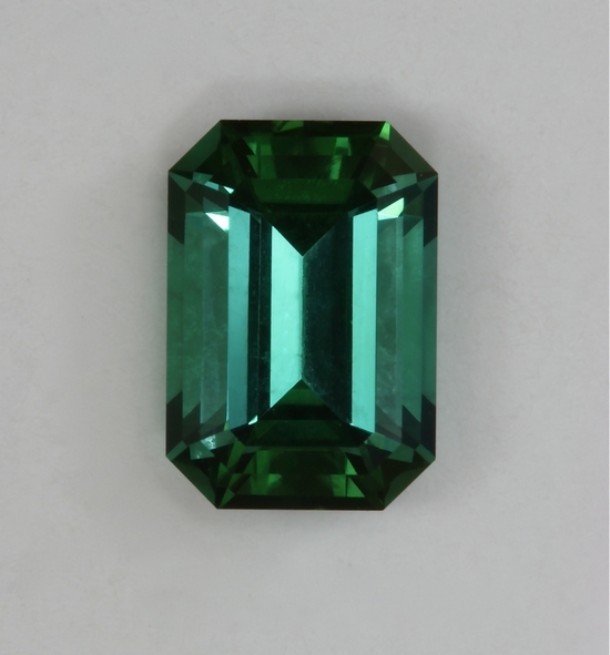 Medium plus tone level in an open ended green emerald cut.  #440