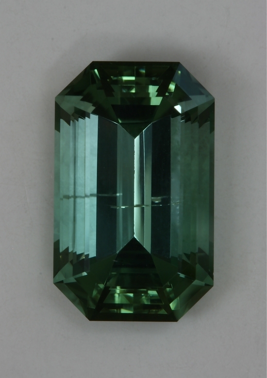 Flawed emerald cut with medium light toned blue green color  #449