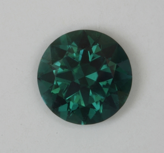 Darker toned blue green with limited flash, round.