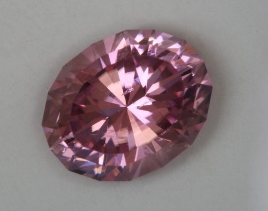 Medium lightly toned pink oval with two stepped crown.