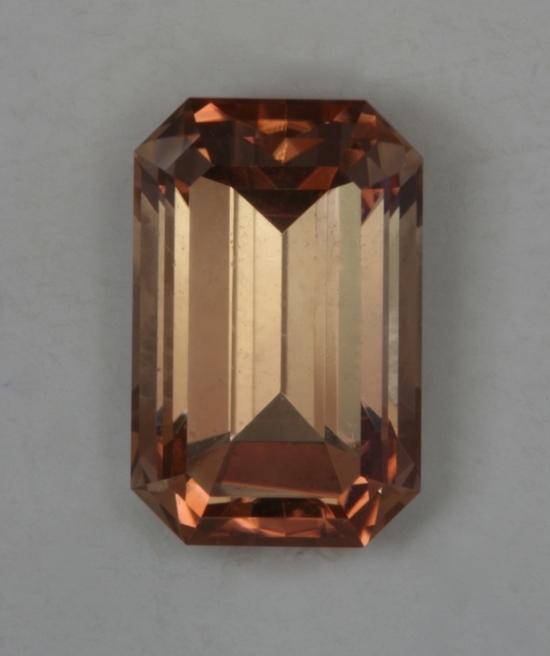 Medium light toned pastel yellow orange emerald cut.
