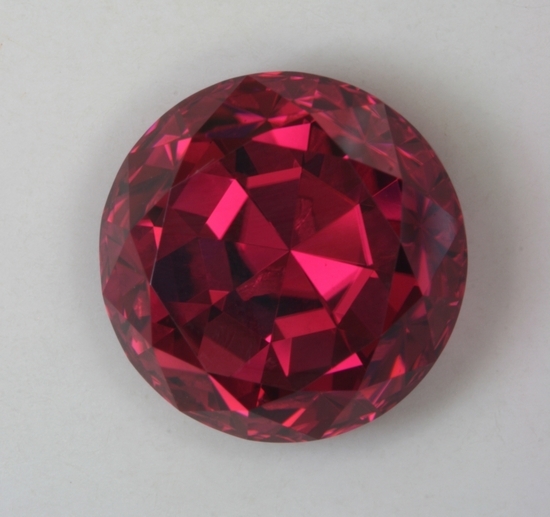 A cherry red, deeply cut, round, GEM