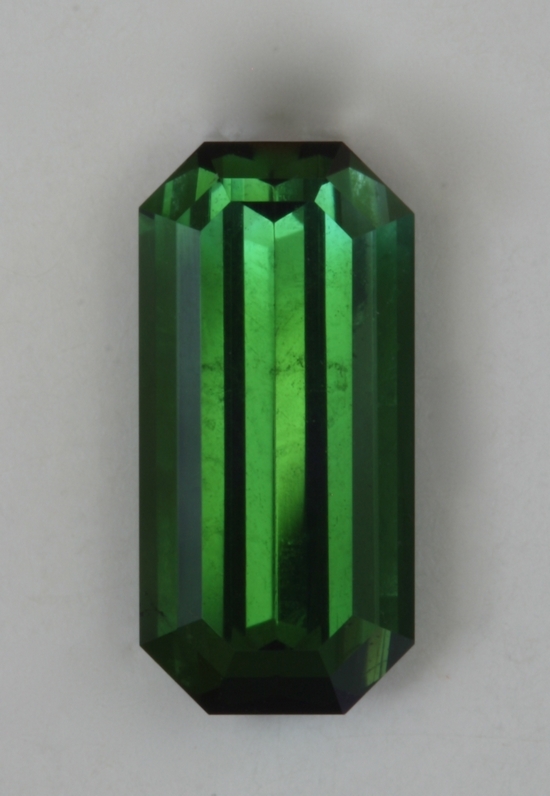 Closed ended, long ratio,spicy green emerald cut.