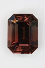 Interesting darker bicolor of pink and brown emerald cut.