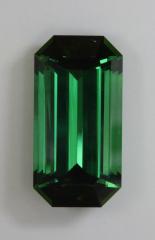 A large tower of green power, emerald cut, with closed ends.