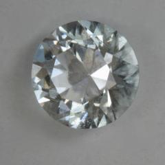 An IceT round with a touch of blue and a sprinkling of inclusions.