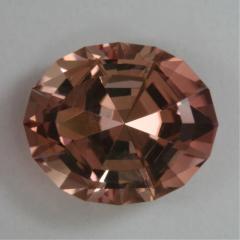 A fine oval of dichroic rust and yellow.