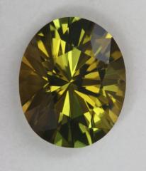 Dichroic darker toned yellow green oval.