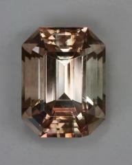 Slightly included pastel peach emerald cut