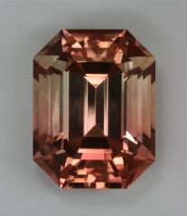Bicolor pastel peach to clear emerald cut.