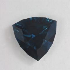 Dark blue trilliant with sapphire blue flash.