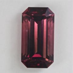 very nice slightly graded maroon emerald cut.