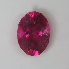 Slightly included hot red/pink oval