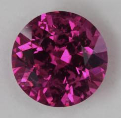 Slightly included hot pink droplet of color.