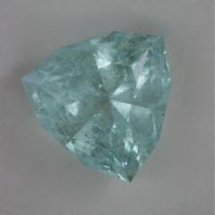 Pale, included, blue with a diffuse glow, shield cut.