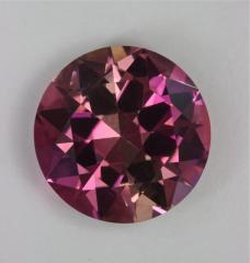 A find round with four alternating slices of dichroic color.