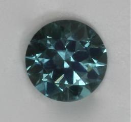 Smallest gemstone I ever cut.  A blue dot of color.