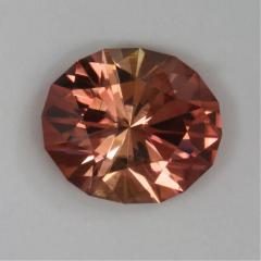 A fine dichroic oval of lighter to medium dark peach