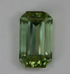 Lovely, not dichroic, lightly toned, green emerald cut.