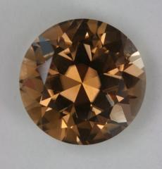 Five carat round with subtle yellow orange color.