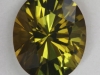 Dichroic darker toned yellow green oval.