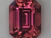 Full cut emerald cut with a great pink on the orange side.