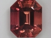 A beautiful GEM in pink and orange, emerald cut.