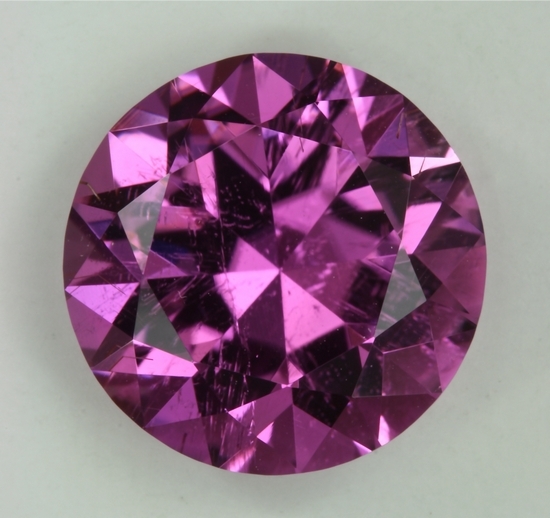 One faint feather and beautiful reddish purple colored round.  #487