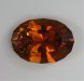 Medium toned, burnt orange, oval.  #573