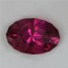 This rich pink to orange hued oval has a couple of white, eye visible, inclusions.  #659