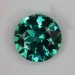 Slightly included bright flashy teal colored round.  #696