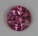 Tinny, moderately included hot pink flashing, round.  #777