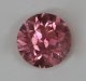 Small slightly included hot pink round.  #795