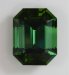 A large emerald cut with mildly dichroic grass green and a more yellowish green color.  #807
