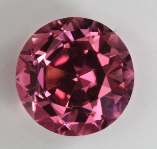 Deeply cut, medium toned, very bright pink, round.