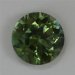This slightly included round has a medium toned green color.  #907