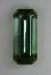 This long ratio emerald cut has a medium light tone.  And it has a medium green and transparent appearance.  #982
