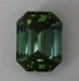 Mildly dichroic, medium toned, highly transparent emerald cut.  #988